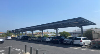 Solar panels mounted above the car park spaces at a supermarket in Alzonne, France